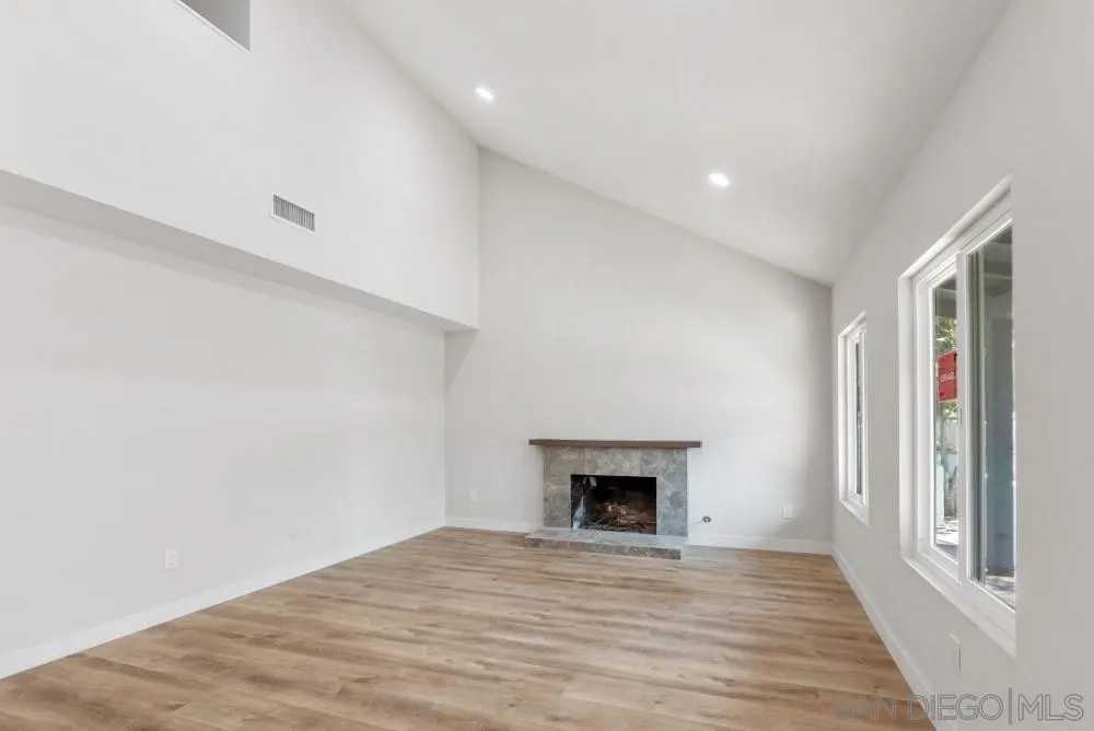 13765 Celestial Road Poway, CA 92064 - Photo 9 of 59 a view of empty room with wooden floor and fireplace