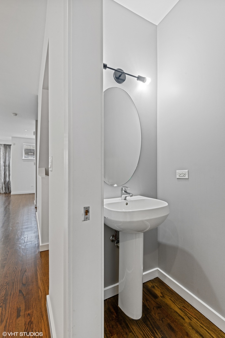 18 South Aberdeen Street, Unit 2 Chicago, IL 60607 - Photo 19 of 26 a bathroom with a sink and mirror