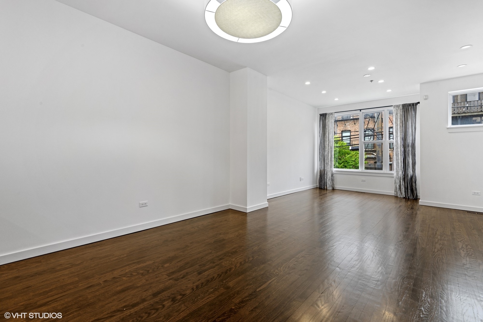 18 South Aberdeen Street, Unit 2 Chicago, IL 60607 - Photo 4 of 26 an empty room with wooden floor and windows