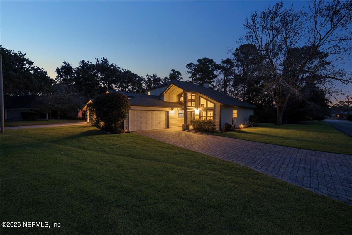 13075 Seedling Way Jacksonville, FL 32246 - Photo 1 of 48 a front view of a house with a garden and yard