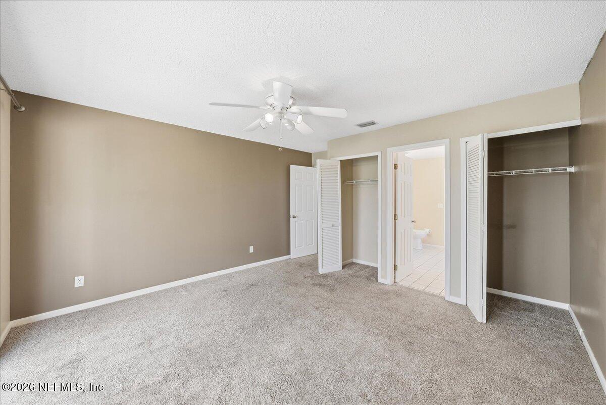 13075 Seedling Way Jacksonville, FL 32246 - Photo 13 of 48 a view of an empty room with a ceiling fan