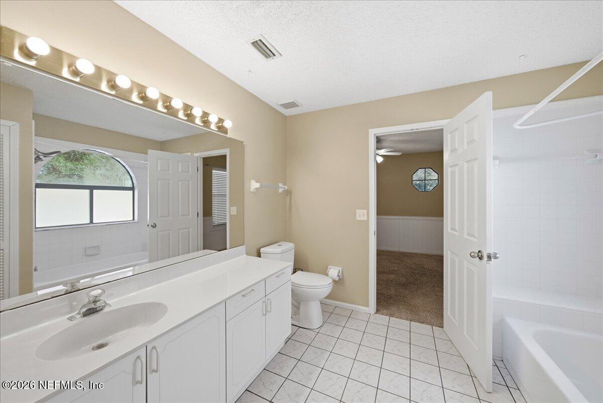 13075 Seedling Way Jacksonville, FL 32246 - Photo 14 of 48 a bathroom with a double vanity sink toilet and shower