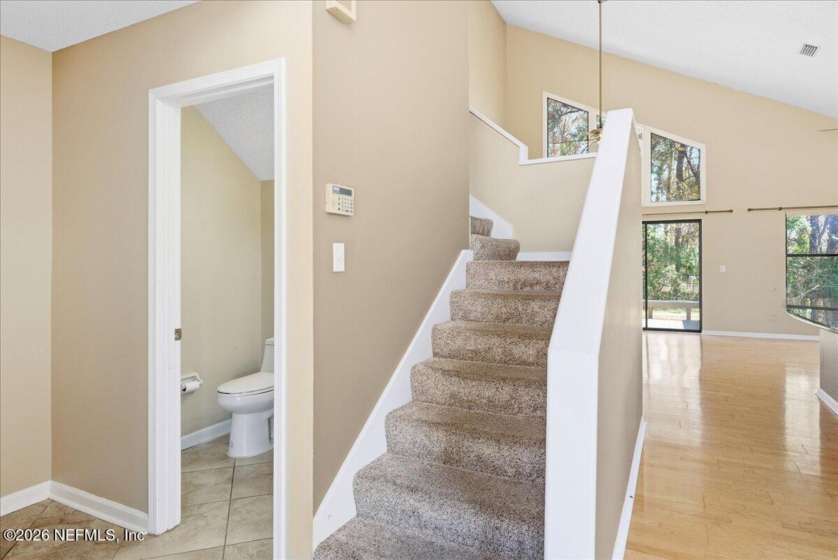 13075 Seedling Way Jacksonville, FL 32246 - Photo 16 of 48 a view of a hallway with wooden floor and a living room