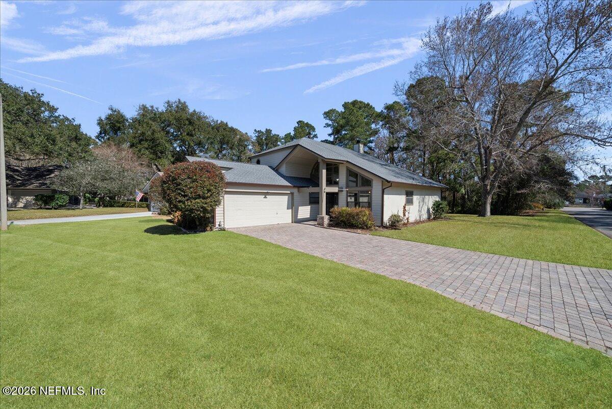 13075 Seedling Way Jacksonville, FL 32246 - Photo 2 of 48 a front view of a house with a yard