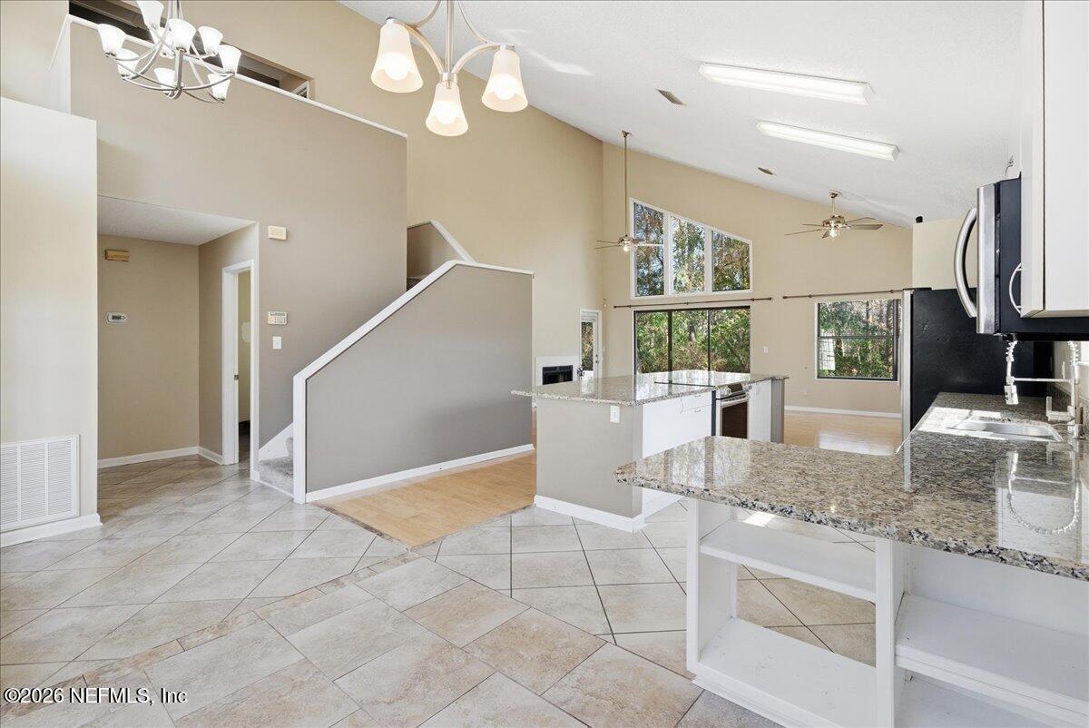13075 Seedling Way Jacksonville, FL 32246 - Photo 8 of 48 a view of a kitchen with kitchen island granite countertop living room and stainless steel appliances