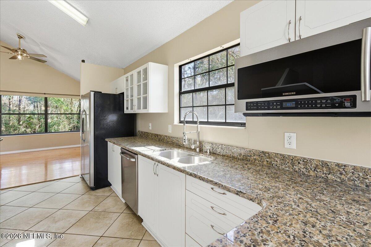 13075 Seedling Way Jacksonville, FL 32246 - Photo 9 of 48 a kitchen with a sink and a stove top oven