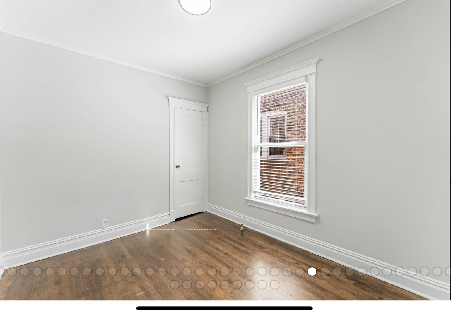 6241 South Troy Street, Unit 2 Chicago, IL 60629 - Photo 13 of 17 a view of an empty room with wooden floor and a window