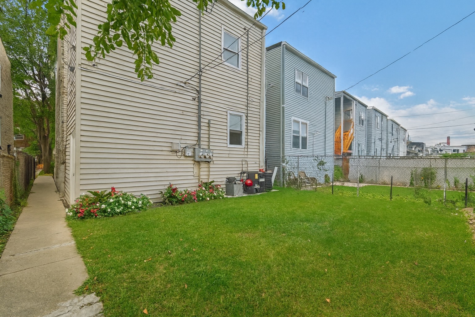 6241 South Troy Street, Unit 2 Chicago, IL 60629 - Photo 17 of 17 a front view of a house with a garden