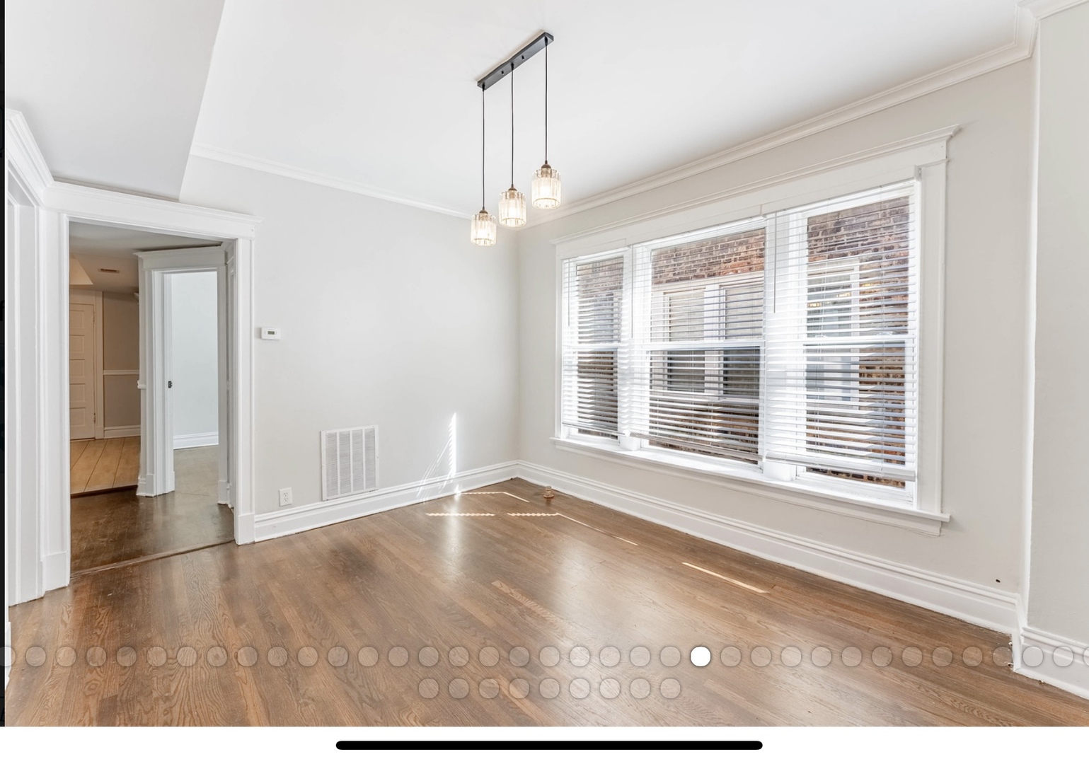 6241 South Troy Street, Unit 2 Chicago, IL 60629 - Photo 6 of 17 a view of an empty room with wooden floor and a window