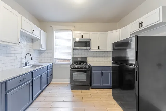 a kitchen with a refrigerator sink and stove