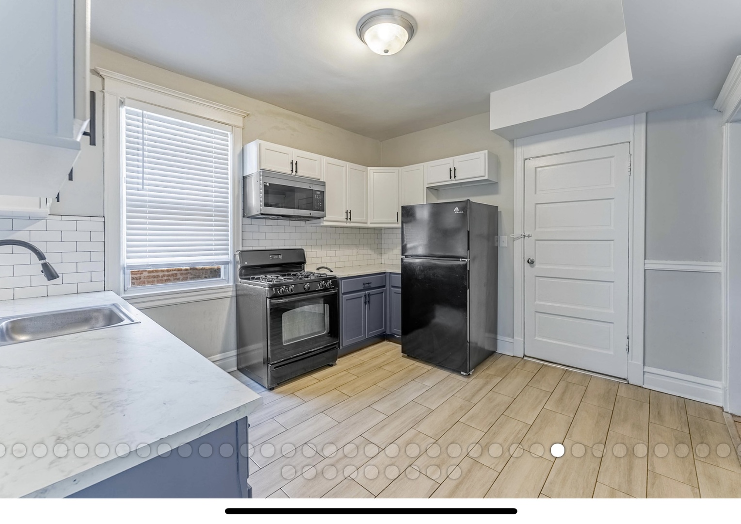 6241 South Troy Street, Unit 2 Chicago, IL 60629 - Photo 10 of 17 a kitchen with a refrigerator sink and wooden cabinets