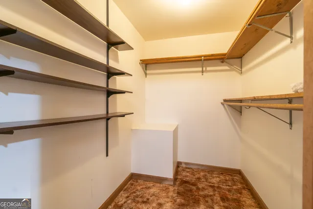 a view of a yard with trees in the background