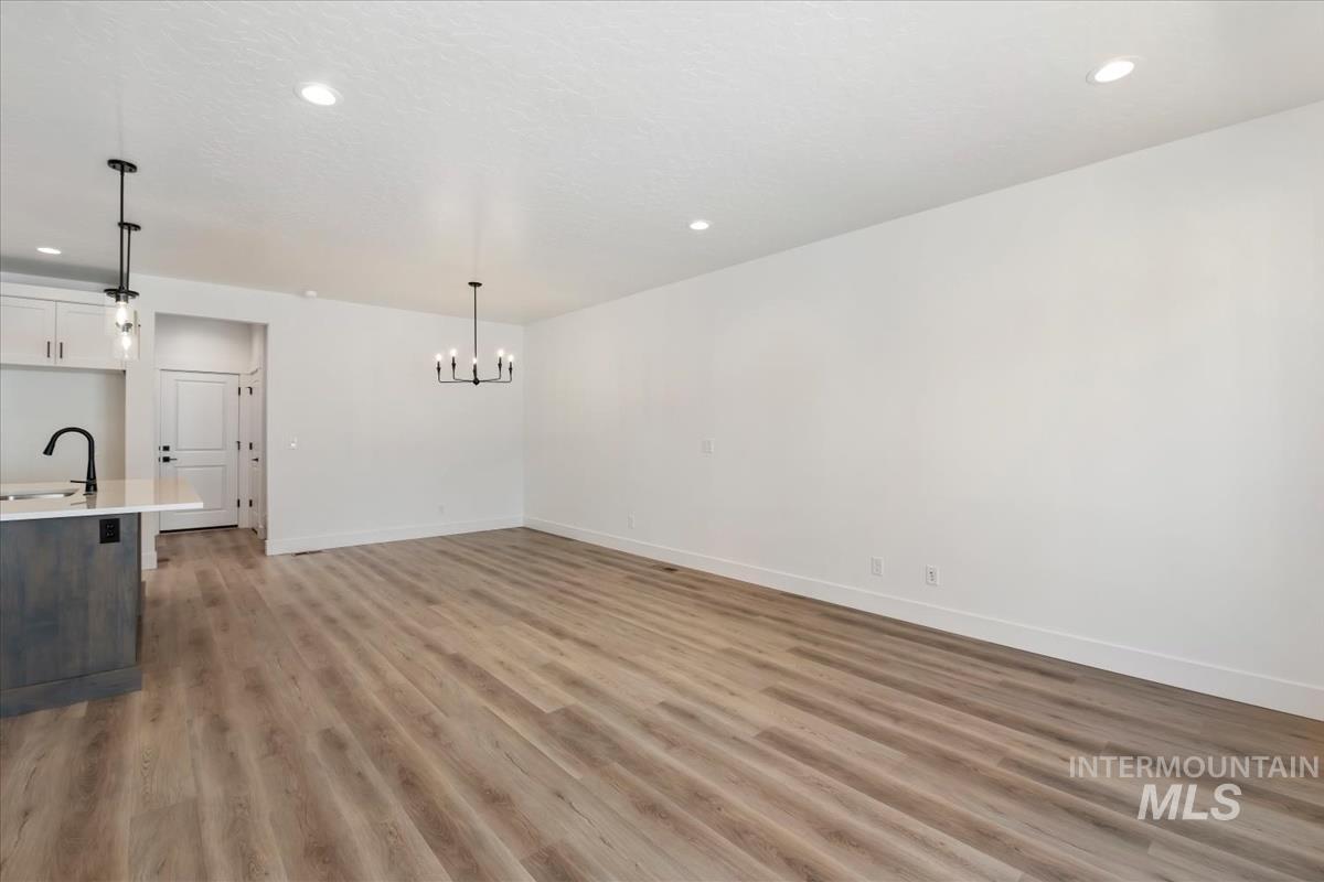 768 South Calhoun Lane Star, ID 83669 - Photo 5 of 36 Open-concept living space with wood-finish flooring