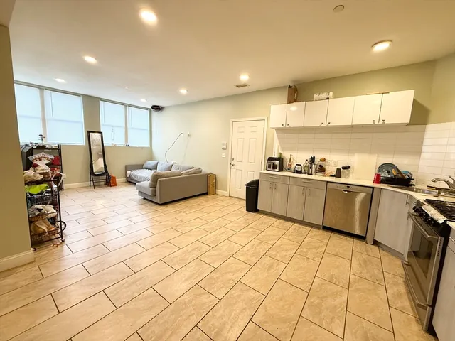 a large room with kitchen view