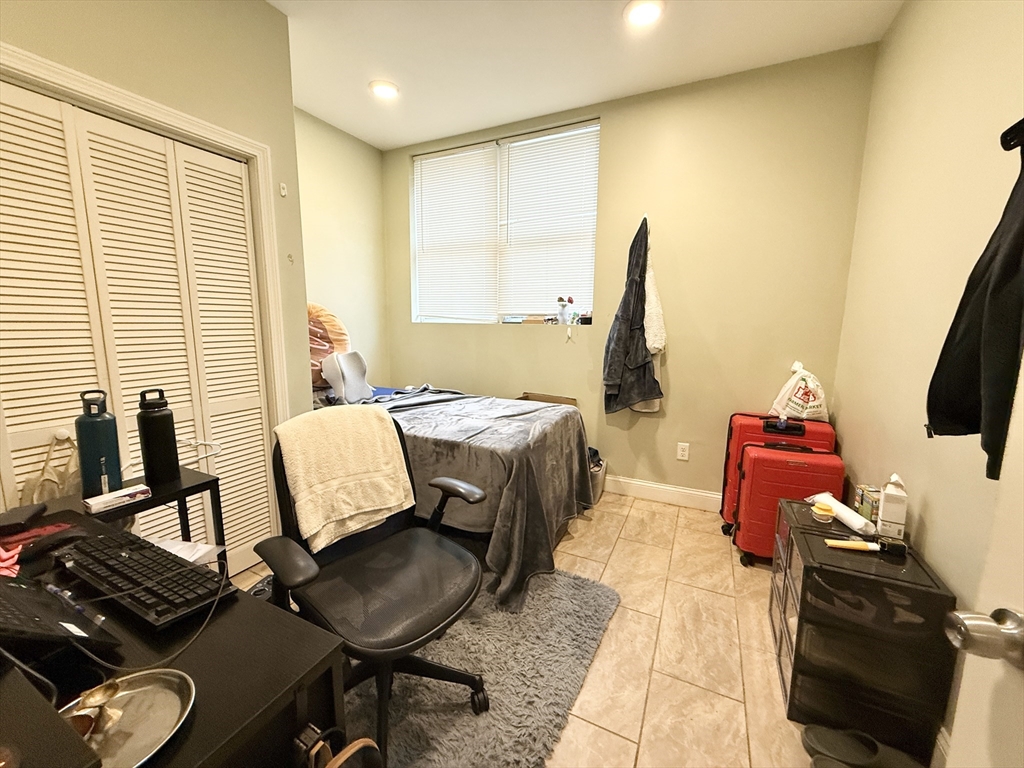 299 Dudley Street, Unit 1 Boston, MA 02119 - Photo 6 of 10 a living room with furniture and a flat screen tv
