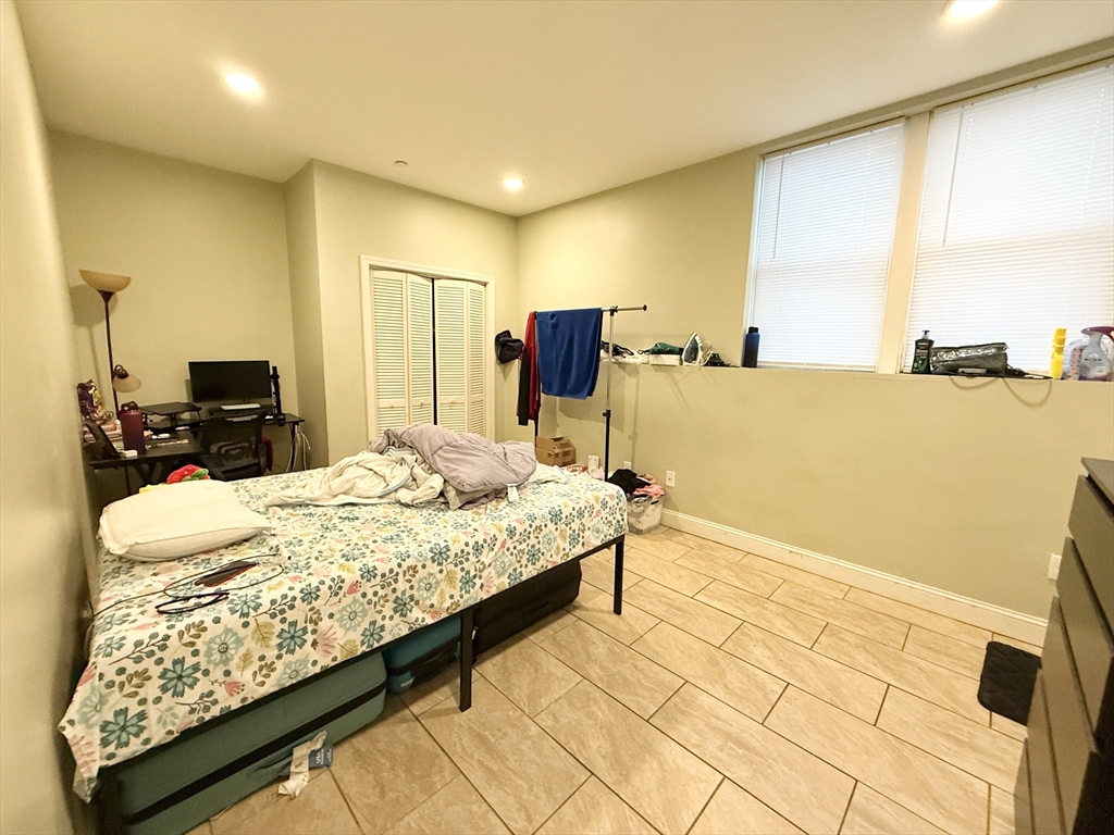 299 Dudley Street, Unit 1 Boston, MA 02119 - Photo 7 of 10 a bed room with a bed