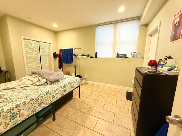 a bedroom with a bed and a dresser in it