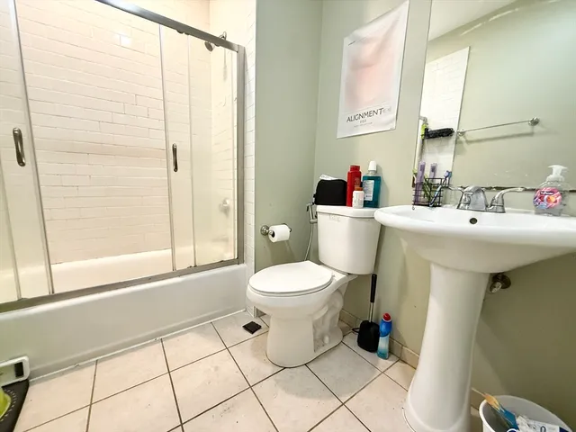 a bathroom with a sink a toilet and a mirror