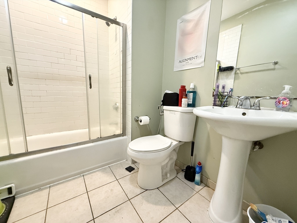 299 Dudley Street, Unit 1 Boston, MA 02119 - Photo 10 of 10 a bathroom with a sink a toilet and a mirror