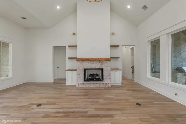a view of a livingroom with a fireplace and window