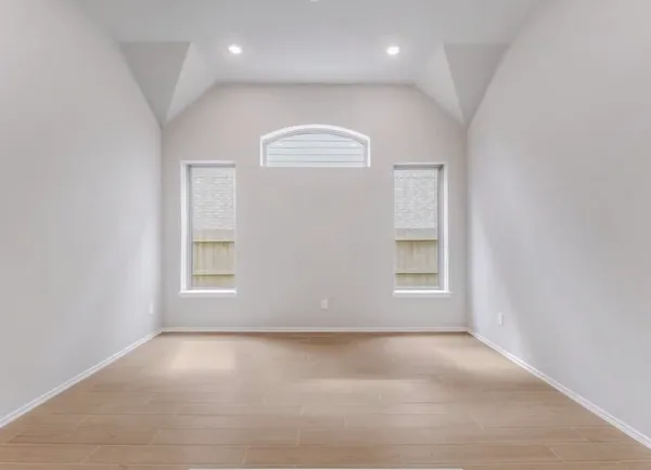 an empty room with a window and closet