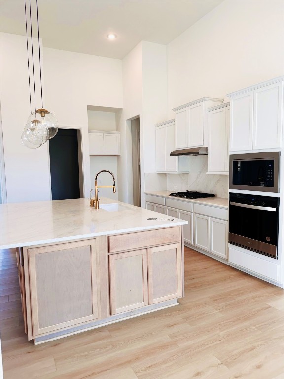 4918 Mango Pk Lane Manvel, TX 77578 - Photo 10 of 28 a kitchen with stainless steel appliances a stove top oven and cabinets