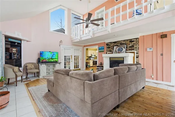 a living room with furniture a fireplace and a large window