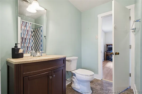 a bathroom with a sink a toilet and mirror