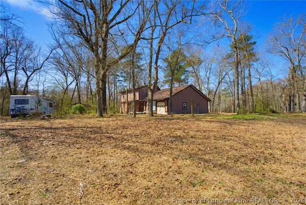 a view of a backyard with large trees