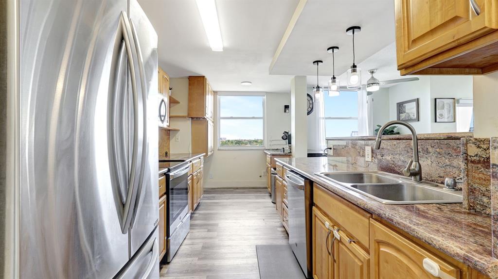 4400 Hillcrest Drive, Unit 719C Hollywood, FL 33021 - Photo 12 of 39 a kitchen with a sink refrigerator and cabinets