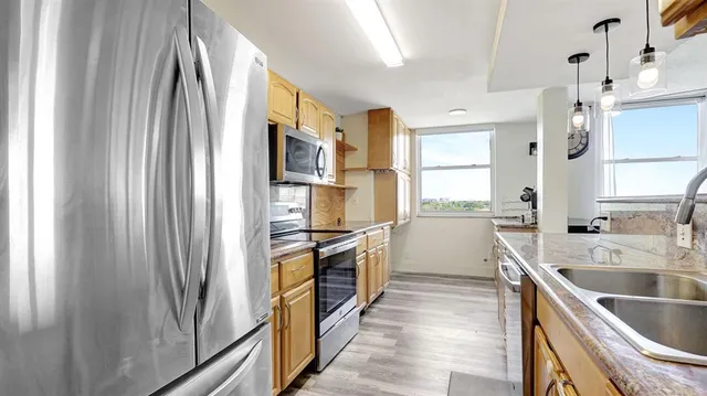 a kitchen with a sink stove and cabinets