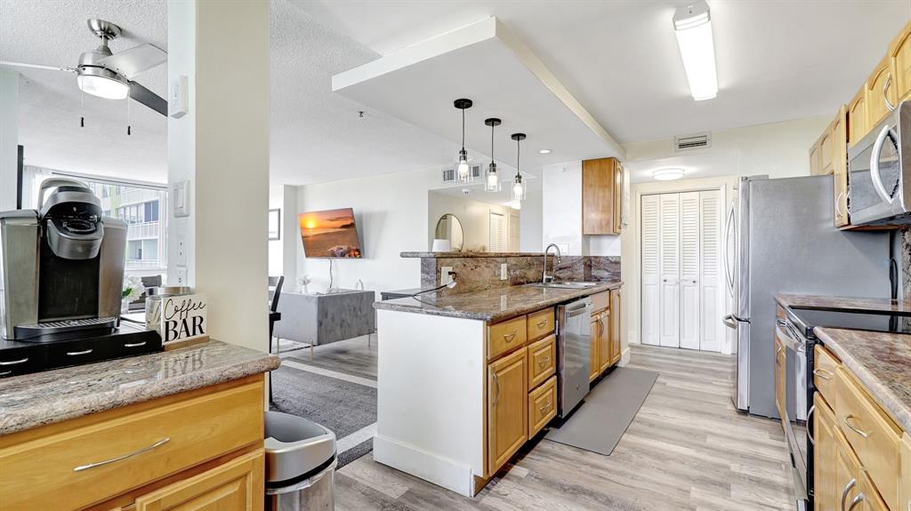 4400 Hillcrest Drive, Unit 719C Hollywood, FL 33021 - Photo 15 of 39 a kitchen with stainless steel appliances granite countertop a stove and a sink
