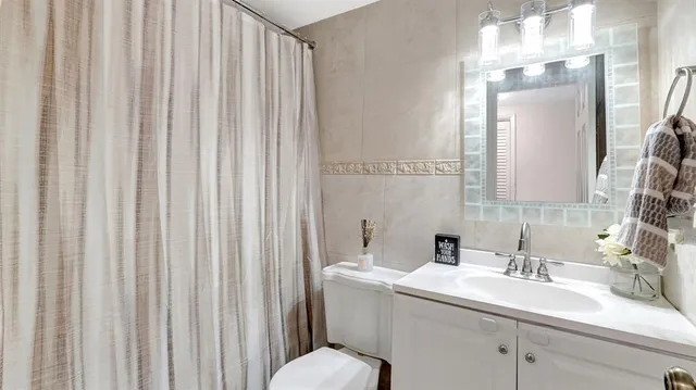 a living room with furniture a flat screen tv and a large window