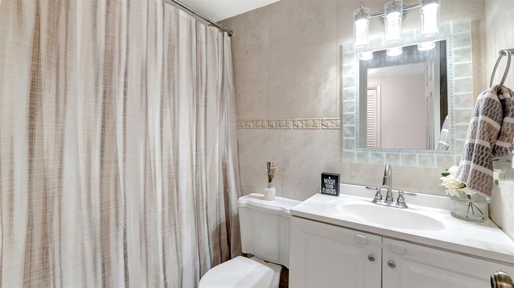 4400 Hillcrest Drive, Unit 719C Hollywood, FL 33021 - Photo 21 of 39 a bathroom with a sink and a mirror