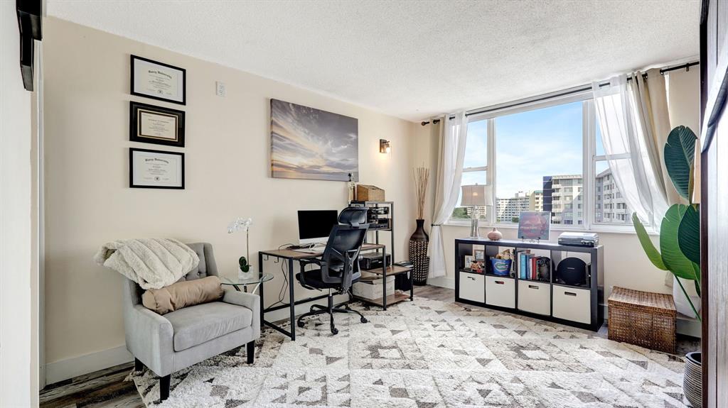 4400 Hillcrest Drive, Unit 719C Hollywood, FL 33021 - Photo 23 of 39 a living room with furniture a flat screen tv and a large window