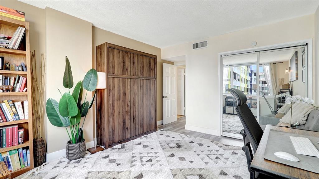 4400 Hillcrest Drive, Unit 719C Hollywood, FL 33021 - Photo 24 of 39 a view of a bedroom with furniture and front door