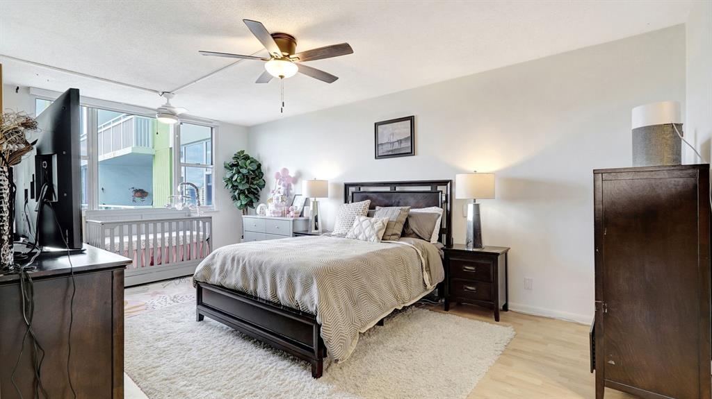 4400 Hillcrest Drive, Unit 719C Hollywood, FL 33021 - Photo 29 of 39 a bedroom with a bed and a chandelier