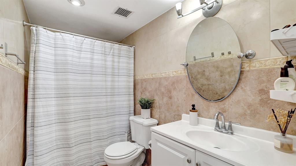 4400 Hillcrest Drive, Unit 719C Hollywood, FL 33021 - Photo 31 of 39 a bathroom with a sink a toilet and shower curtain
