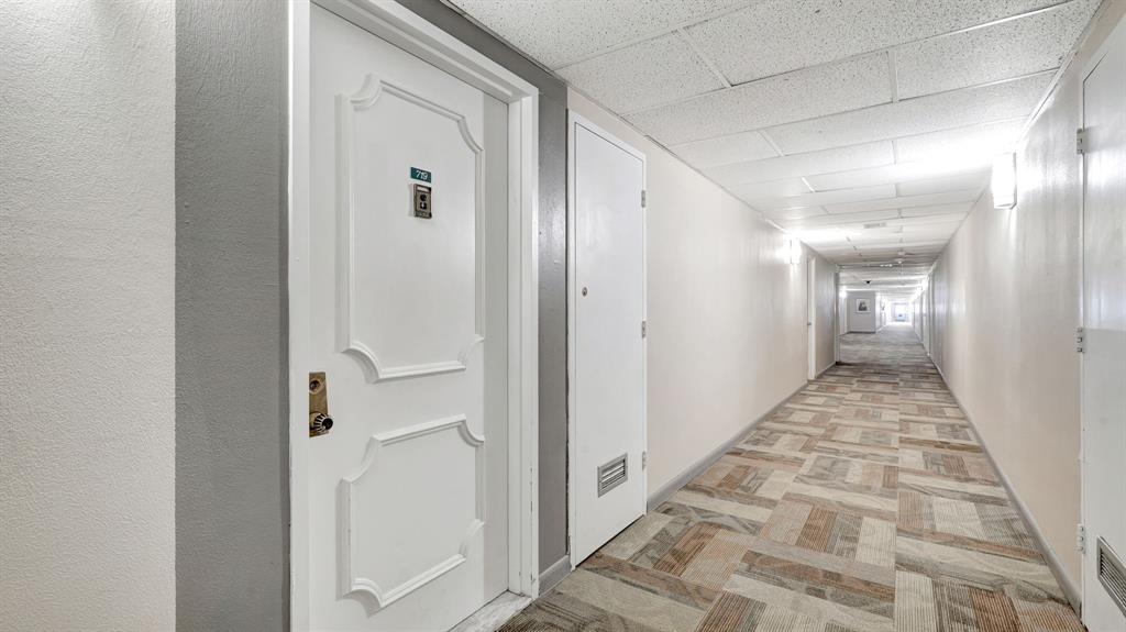 4400 Hillcrest Drive, Unit 719C Hollywood, FL 33021 - Photo 33 of 39 a view of a hallway with wooden floor and a bathroom