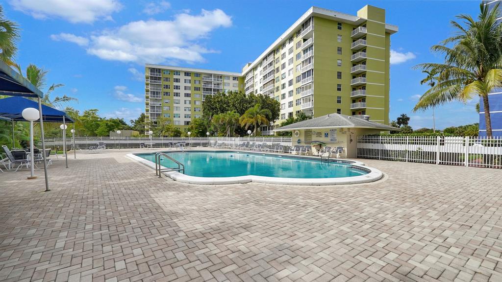 4400 Hillcrest Drive, Unit 719C Hollywood, FL 33021 - Photo 37 of 39 a view of a swimming pool with a lawn chairs