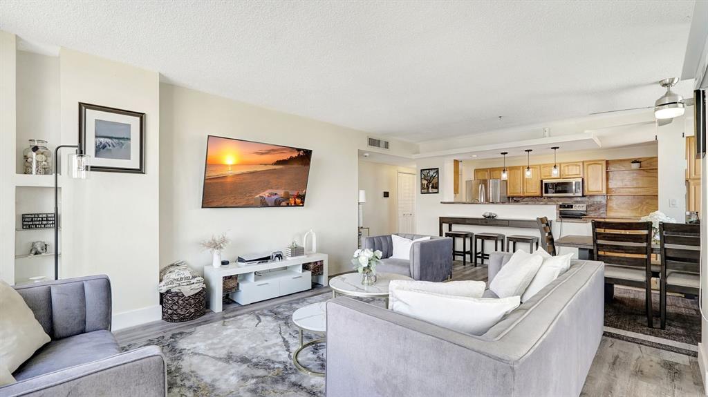 4400 Hillcrest Drive, Unit 719C Hollywood, FL 33021 - Photo 6 of 39 a living room with furniture and a flat screen tv