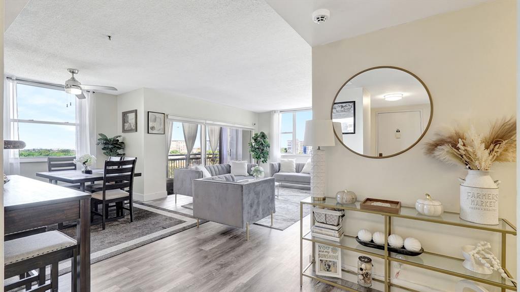 4400 Hillcrest Drive, Unit 719C Hollywood, FL 33021 - Photo 7 of 39 a living room with furniture a mirror and a wooden floor
