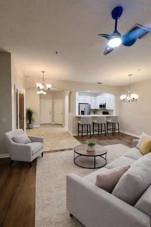 a living room with furniture and a chandelier