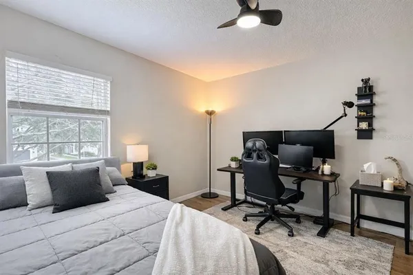 a bed room with a bed and a chair