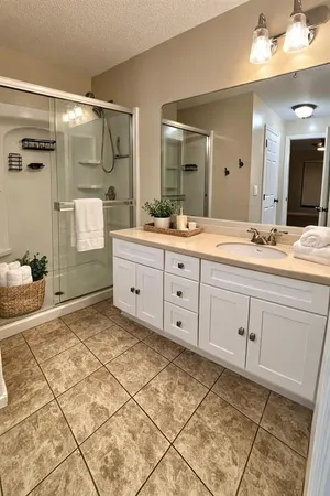 a spacious bathroom with a granite countertop sink mirror and a