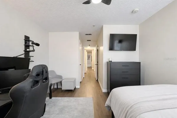 a bedroom with a bed and a television