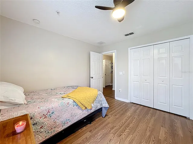 a bedroom with a bed and a lamp