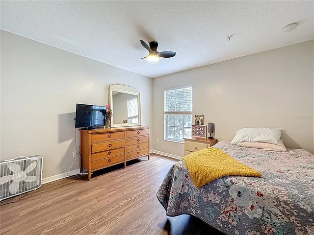 a bedroom with a bed and wooden floor