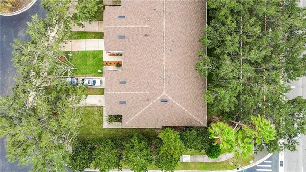 an aerial view of a house with a yard