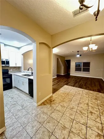 a large kitchen with a stove a sink dishwasher and a refrigerator